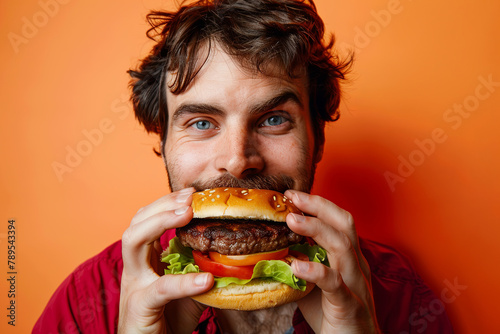 A man enjoying a synthetic meat burger