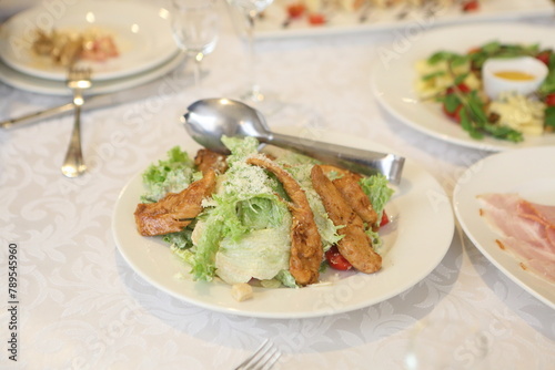 Caesar salad with chicken on white background