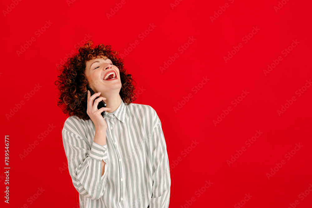 Happy woman making phone call