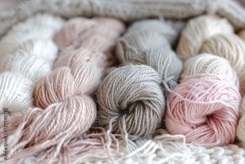 An assortment of wool bundles in varying shades of pink and grey, offering a feast of textures for handcrafting.
