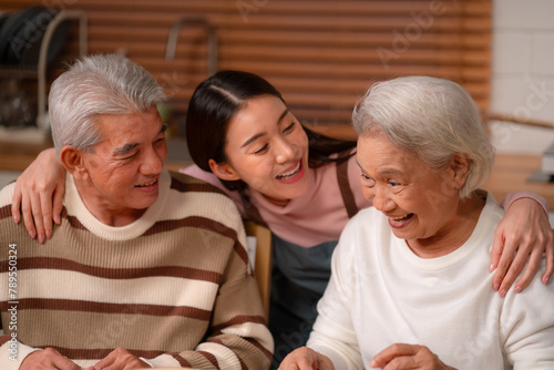 Family Togetherness in the Kitchen: Asian Mother Prepares a Happy Dinner, Joined by Father, Daughter, and Senior Elderly, Creating Fun and Memorable Meals, A Heartwarming Holiday Gathering