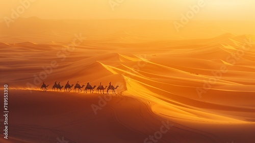 Lovely desert sunset with camel silhouettes on the sand dunes photo