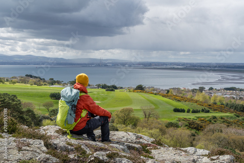 Hiker man admiring the landscape of Dublin Bay, Irish landscape.