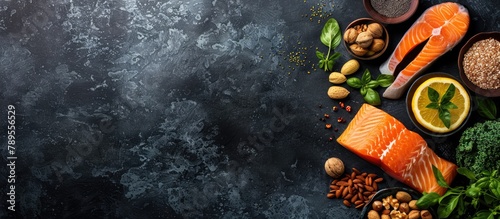 Food sources of omega 3 and healthy fats displayed on a dark background from a top-down perspective, with space for additional content. Included are vegetables, seafood, nuts, and seeds.