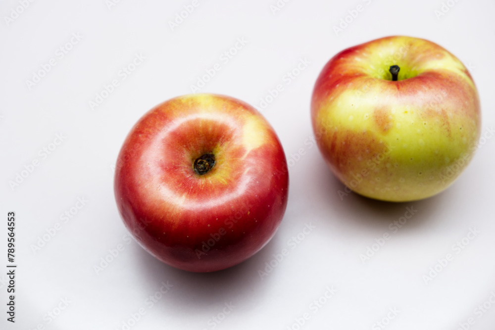 Apples with still-life concept. Close-up beautiful fruit texture of red apples. The concept of a healthy lifestyle, edible fruit, fresh and organic apple. Top view food with white background. Apples with still-life concept. Close-up beautiful fruit texture of red apples. The concept of a healthy lifestyle, edible fruit, fresh and organic apple. Top view food with white background.