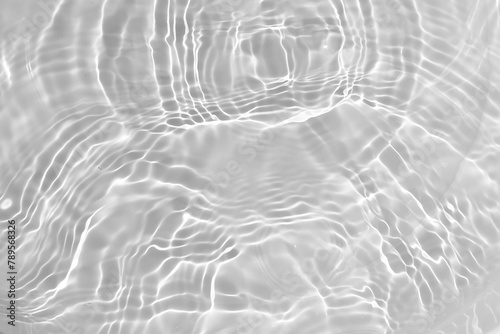 White water surface with ripples. White water texture with sprays and bubbles resting on the surface. Abstract summer background with water waves in sunlight and copy space for cosmetic products