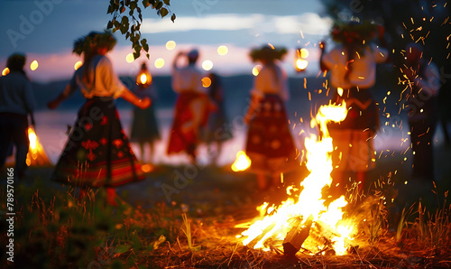 People dancing around a Midsummer Bonfire wearing traditional wreaths on their heads. Midsummer celebration concept.