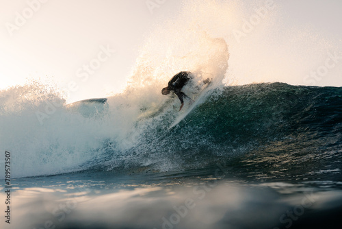 An underwater camera captures a professional surfer executing a trick photo
