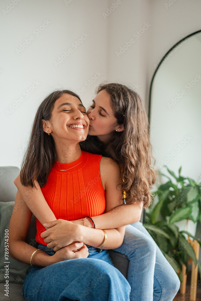 Young Woman Kissing Her Girlfriend Young Woman Kissing Her Girlfriend