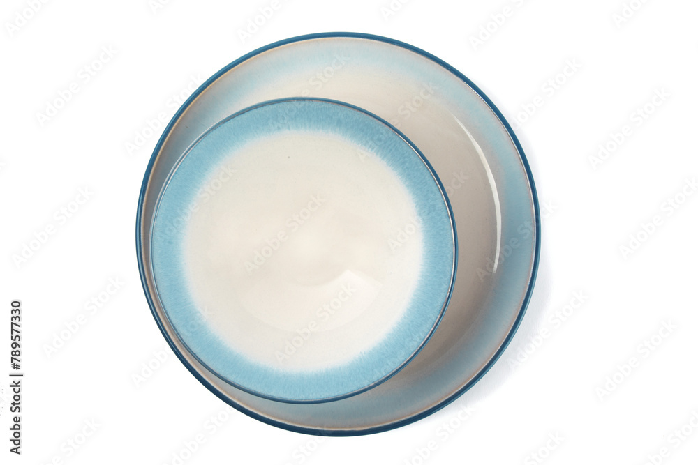 overhead view of a blue soup bowl on a blue dinner plate isolated on white overhead view of a blue soup bowl on a blue dinner plate isolated on white