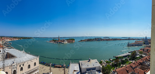 Aerial view from St Mark bell tower Campanile of the old town of Venice, Veneto, Italy, Europe. Looking at Piazza San Marco and the Venetian Lagoon. UNESCO World Heritage Site. Urban tourism in summer