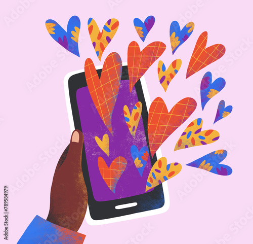 A hand holds a smartphone from which colored hearts fly out photo