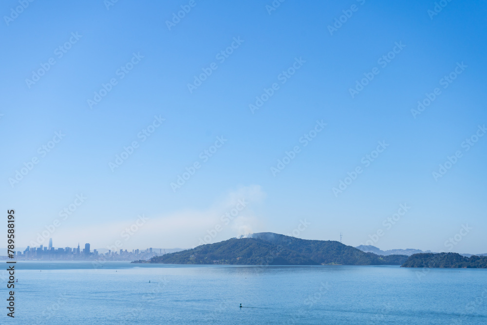 Smoke from a fire on Angel Island on April 8th 2024, with San Francisco in the background. Photographed from the Richmond Bridge