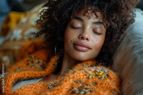 A serene woman enjoys a restful sleep wrapped in an orange knitted sweater, embodying tranquility and comfort photo