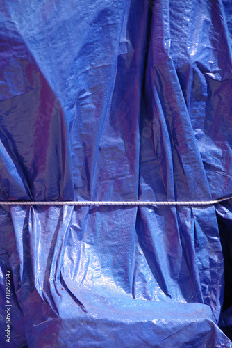 Blue tarp cover wrapped around big items