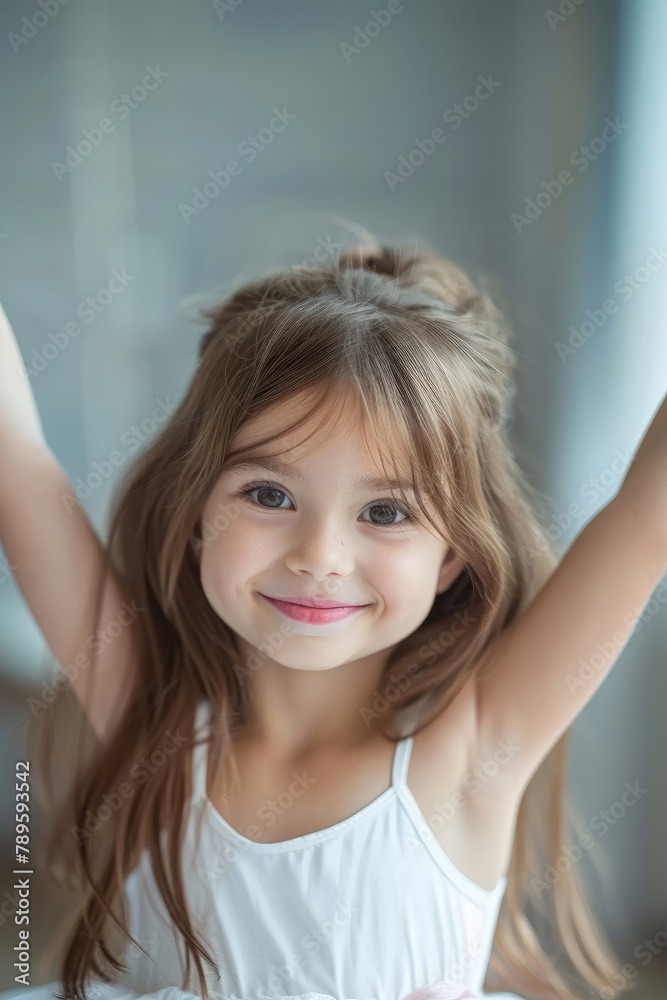 A young girl with long brown hair and a white dress is smiling A young girl with long brown hair and a white dress is smiling