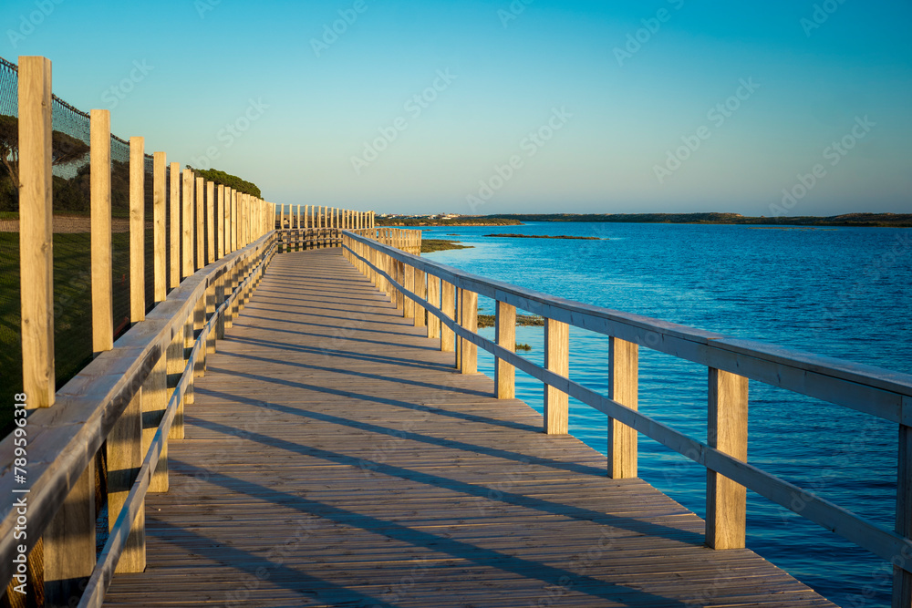 Fototapeta premium View on Rio Formosa wooden boardwalk near Faro in the Algarve, Portugal