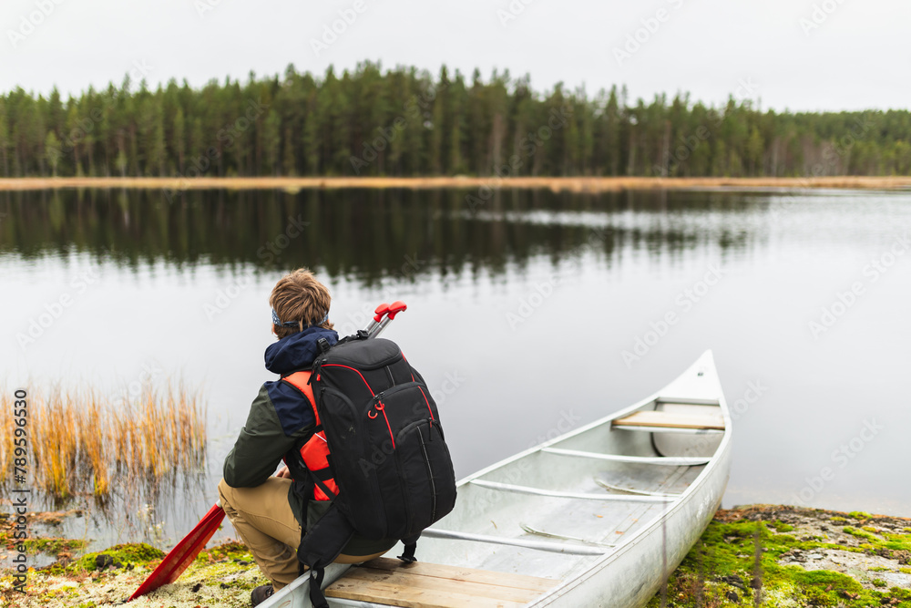 Relaxed man sitting in kayak in wilderness adventure Relaxed man sitting in kayak in wilderness adventure