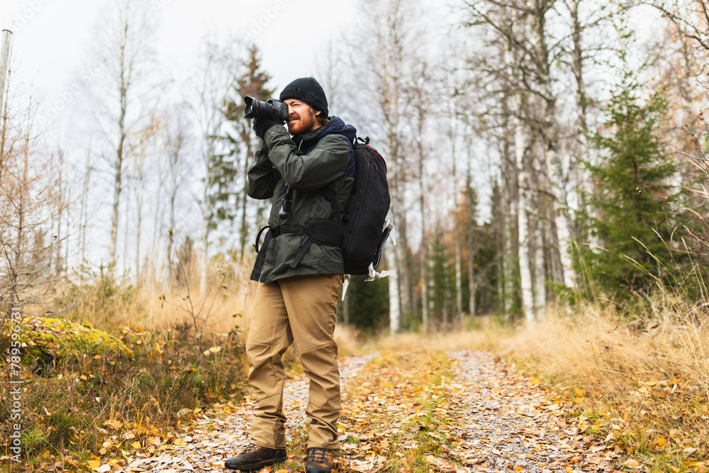 Photographer taking images during a hike exploration Photographer taking images during a hike exploration