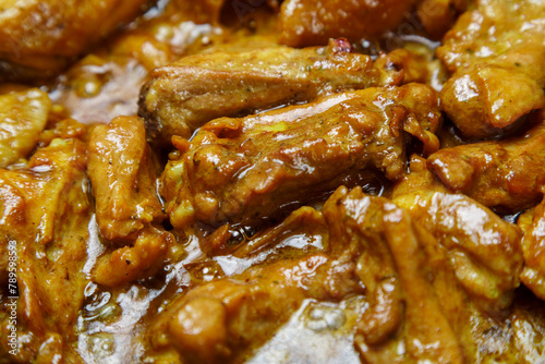 Chicken pieces in a sauce with paprika and turmeric in gravy