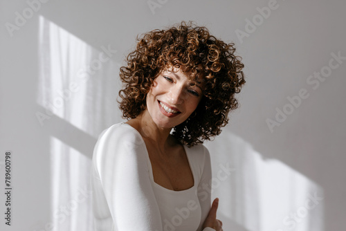 Positive woman with toothy smile in studio photo