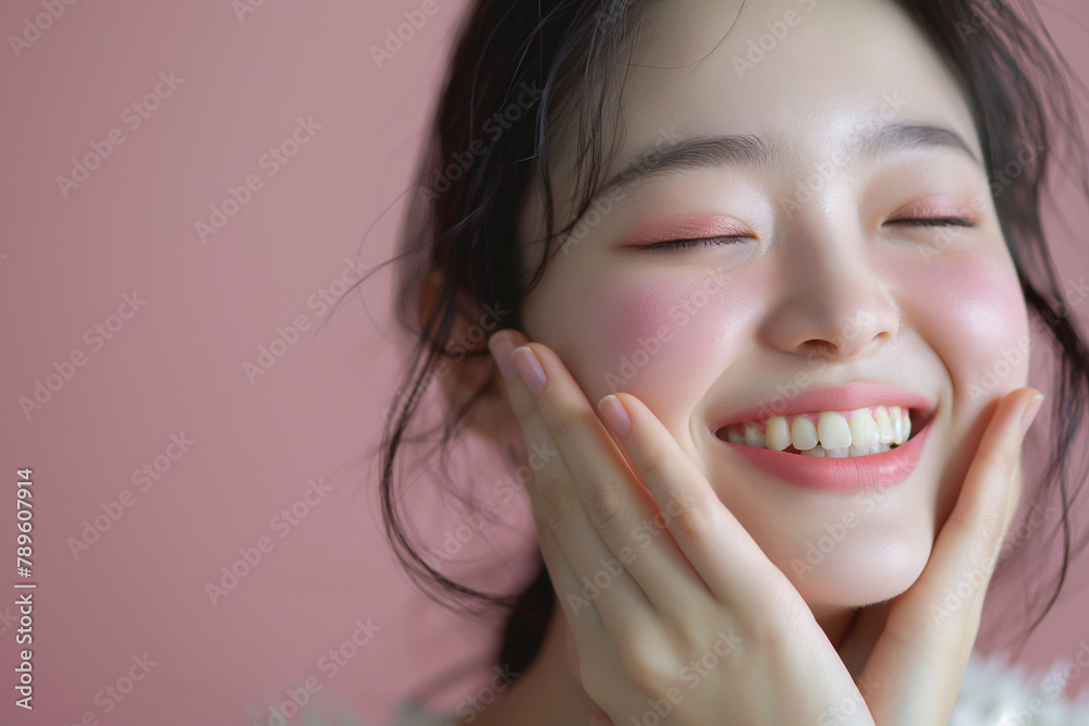 The young Korean woman delicately brushes rosy blush onto her cheeks, her smile reflecting pure joy. The young Korean woman delicately brushes rosy blush onto her cheeks, her smile reflecting pure joy.
