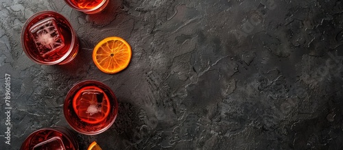 Negroni cocktail displayed on a dark stone table. Top view with room for your own text.