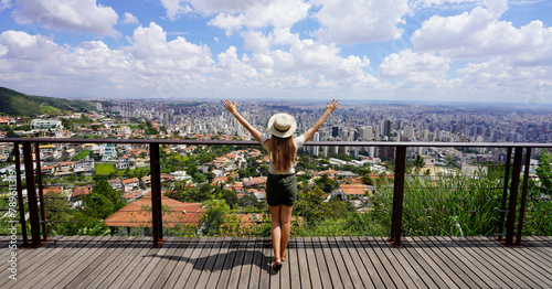 Tourism in Belo Horizonte, Brazil. Panoramic banner view of tourist woman with raising arms from beautiful belvedere in Belo horizonte, Minas Gerais, Brazil. photo