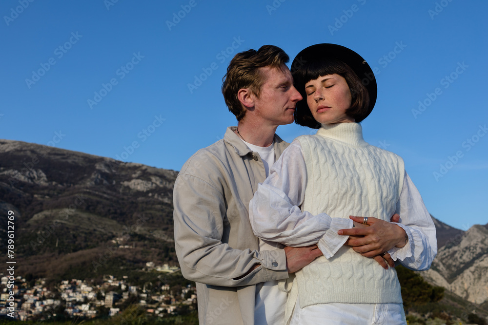 Young couple enjoy each other in mountains at sunset Young couple enjoy each other in mountains at sunset