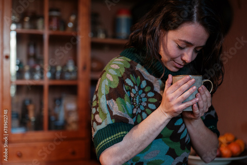 Woman enjoying a cup of hot tea 