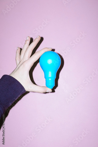 Hand holding  light bulb representing new idea, ideation, eureka photo