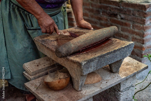 Anonymous Zapotec woman making chocolate photo