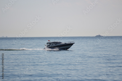 small ship in the sea of marmara with a sail  photo