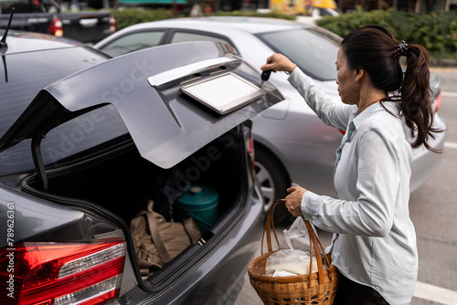 Woman opening the car trunk. photo