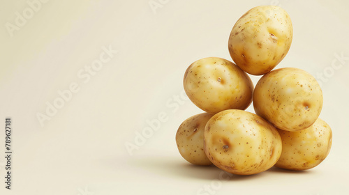 A pyramid of six russet potatoes against a beige background.