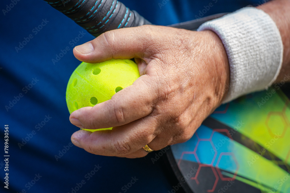 Man holding a racket and ball