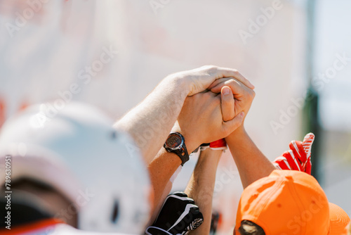 Hands of American footbal players before the game photo