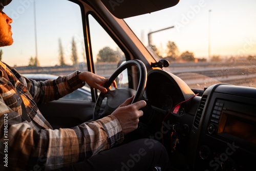 Man driving at sunset photo