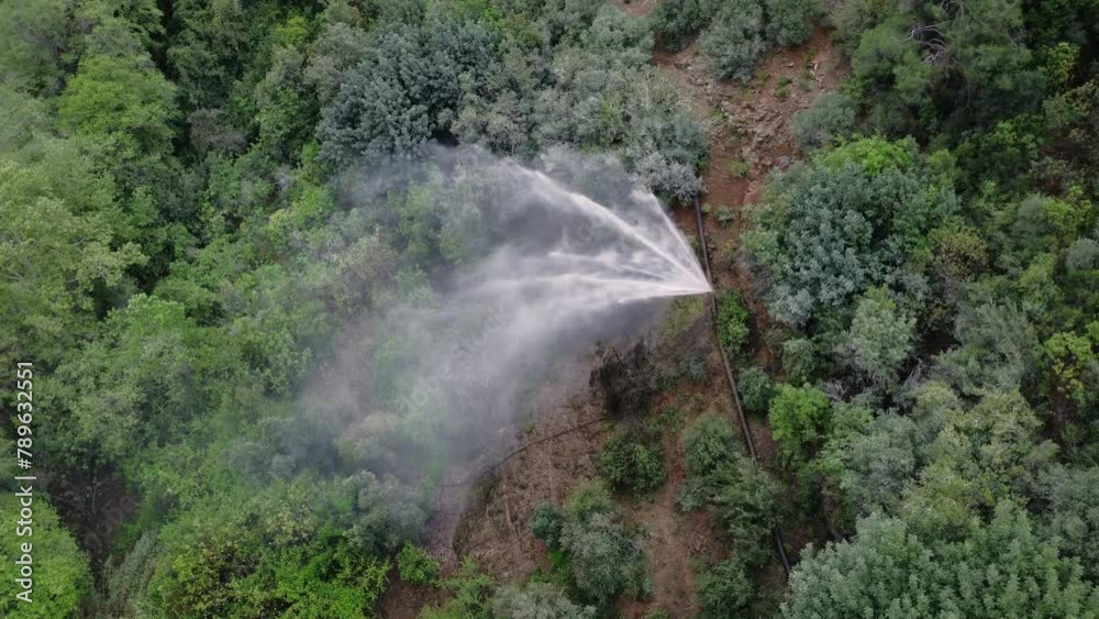 Drone view captures burst pipe, loss of water in green canyon. Aerial footage of burst pipe, loss impacting natural setting. Scene of burst pipe, loss in mountainous environment Drone view captures burst pipe, loss of water in green canyon. Aerial footage of burst pipe, loss impacting natural setting. Scene of burst pipe, loss in mountainous environment