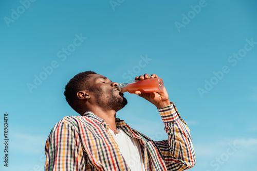 Black man drinking juice photo