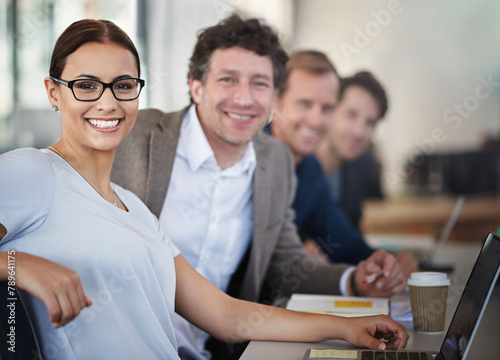 Happy woman, laptop and glasses in meeting with business parters at office desk for strategy planning. Female person, portrait and collaboration in workshop for career, brainstorming and seminar. photo
