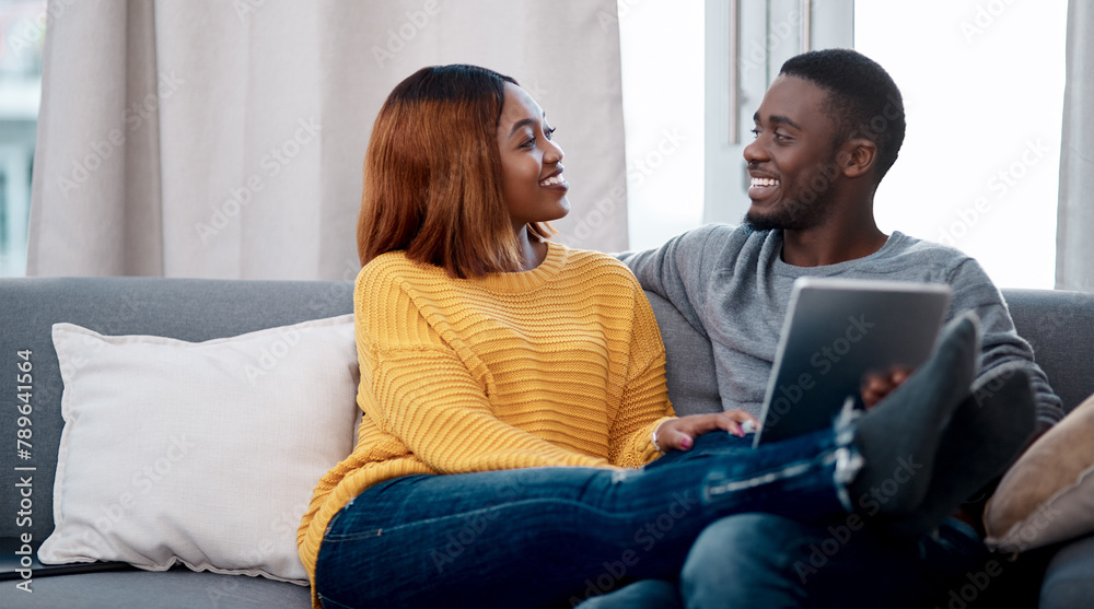 Black couple, tablet and relax with digital app in home for streaming entertainment, movie or internet. Man, woman and sofa in apartment with network subscription for watching, bonding or website Black couple, tablet and relax with digital app in home for streaming entertainment, movie or internet. Man, woman and sofa in apartment with network subscription for watching, bonding or website