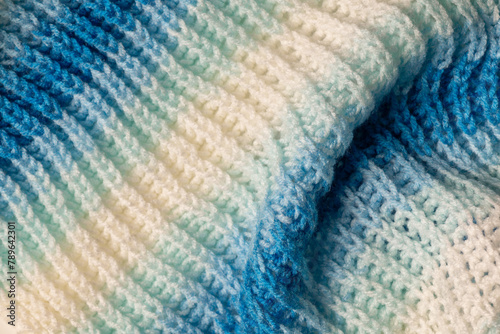 White and blue knitted wool pattern macro photo