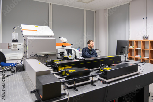 Male Researcher Working With Raman Spectrometer photo