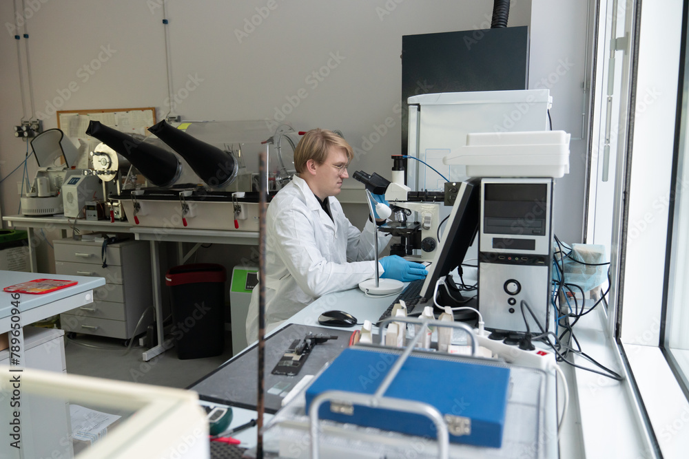 Male Researcher Using The Microscope