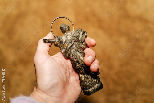 Hand holding religious figure of Saint Pancras that attracts money  photo