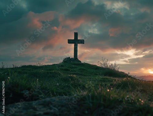 A cross sitting on top of a lush green hillside