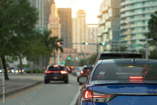 American street with driving cars at intersection with traffic lights in Miami, Florida. USA transportation © bilanol