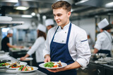 waiter taking plates from a professional kitchen for customers