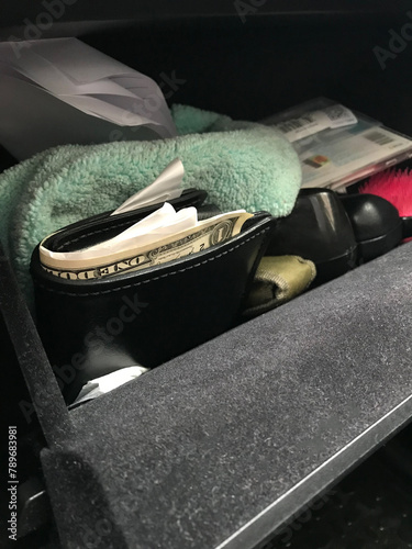 Wallet with money US Dollars and receipt inside car - UGC  photo
